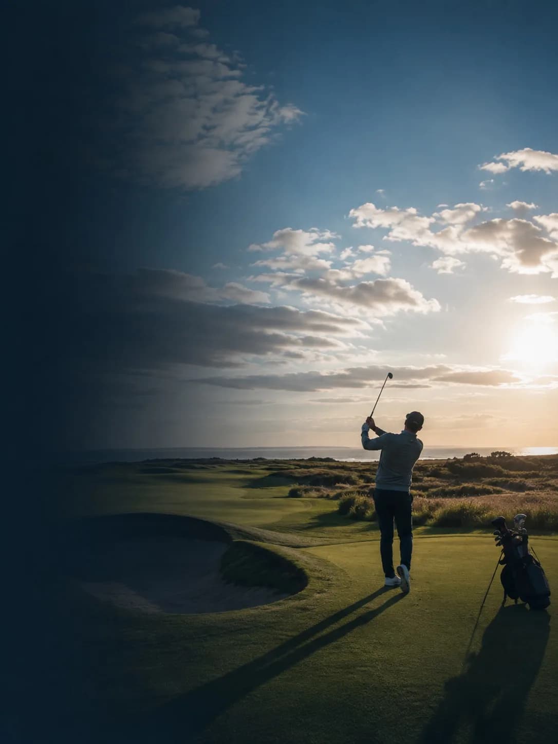 A golfer on a links course at last light