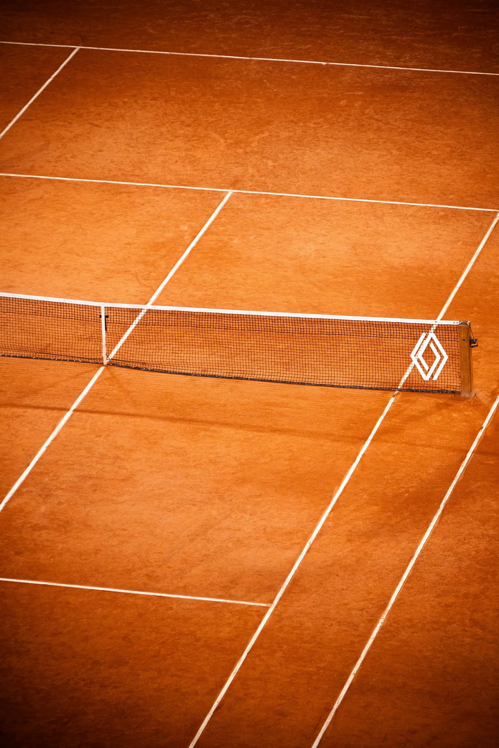 Clay court and net in afternoon light